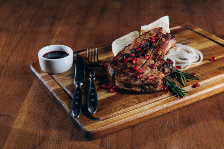 close-up shot of tasty grilled steak served with sauce and pomegranate seedsの写真素材