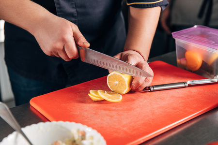 chef slicing lemon at restaurant