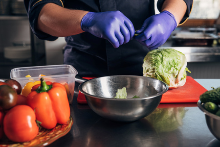 chef cooking vegetables at workplace in restaurantの写真素材