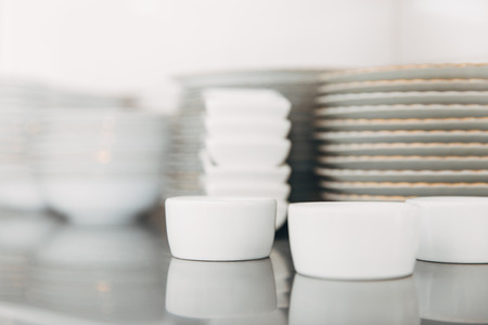 stacks of various clean tableware at restaurant