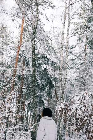 woman walking in snowy forestの写真素材