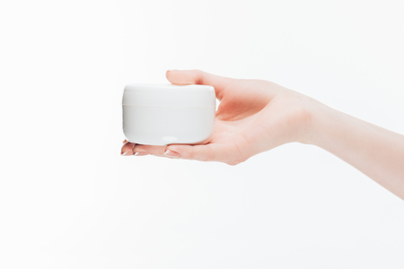 cropped shot of woman holding jar of anti-wrinkle cream isolated on whiteの写真素材