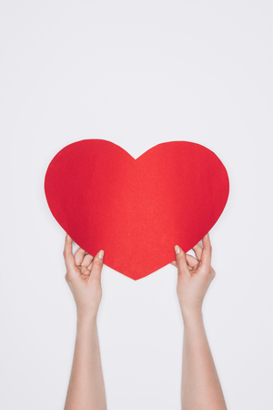 woman holding red heart isolated on whiteの写真素材
