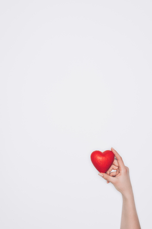 woman holding small red heart isolated on whiteの写真素材