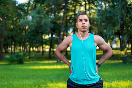 african american sportsman stretching in parkの写真素材