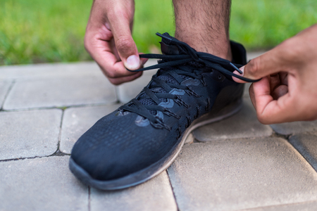 sportsman tying shoelacesの写真素材