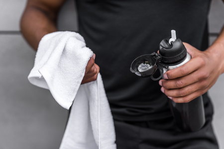 sportsman with sports bottle and towelの写真素材