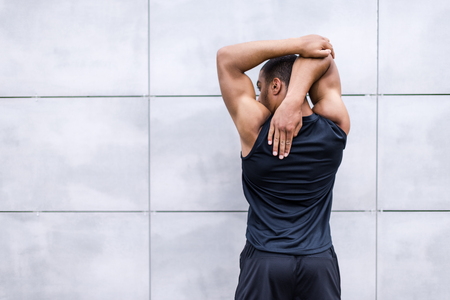 african american runner stretching on streetの写真素材