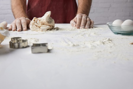 cropped image of chef standing at table with doughの写真素材