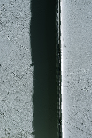close-up view of electrical wires on grey concrete wall backgroundの写真素材
