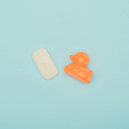soap and baby duck toy isolated on blueの写真素材