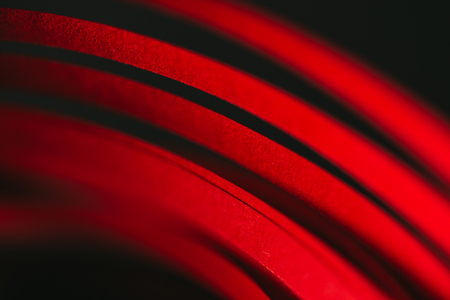 close up view of red quilling striped paper on black の写真素材