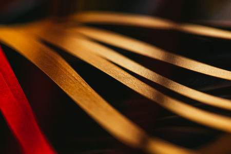close up view of yellow quilling striped paper on black の写真素材