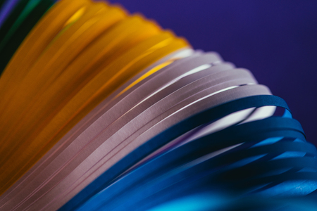close up view of yellow, white and blue quilling paper