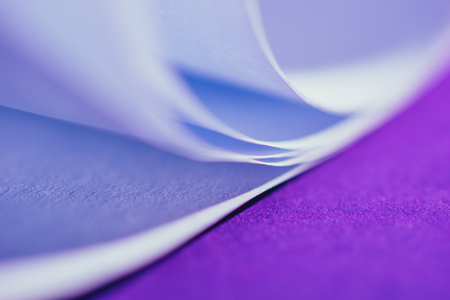 close up view of white paper on purple surfaceの写真素材