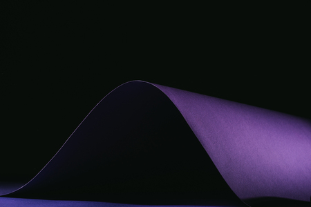 warping simple purple paper on blackの写真素材