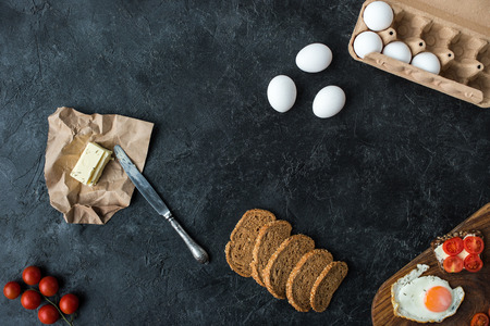 flat lay with ingredients for healthy breakfast on dark tabletopの写真素材
