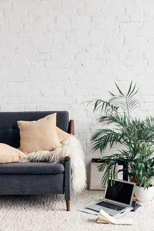 comfy couch in white living room interior with brick wallの写真素材
