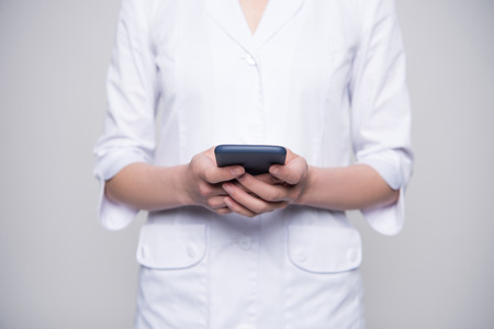 Young nurse holding smartphoneの写真素材