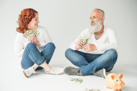 couple with dollars and piggy bankの写真素材