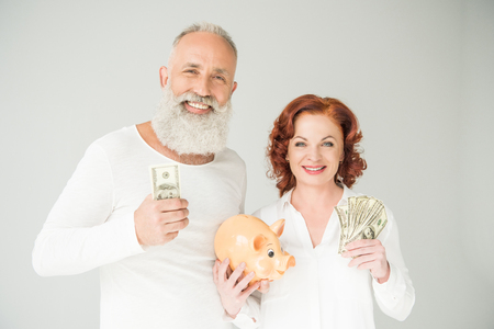 couple with dollars and piggy bankの写真素材
