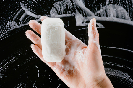 Woman holding soap with foam