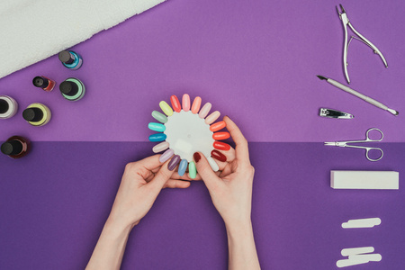 Woman choosing color for nails with manicure paletteの写真素材