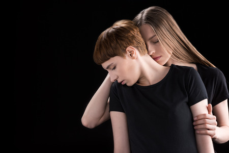 Young woman embracing girlfriendの写真素材