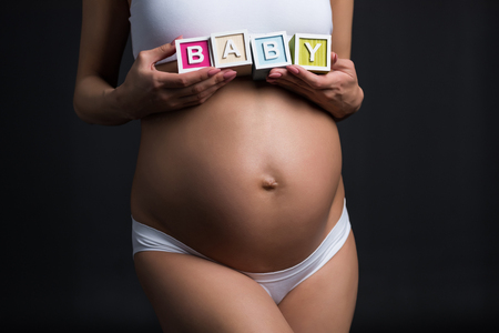 pregnant woman with baby wordの写真素材