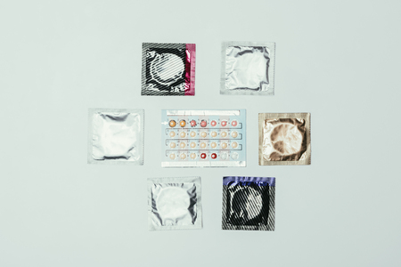 top view of arranged condoms and contraceptive pillsの写真素材