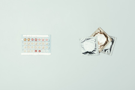 top view of arranged condoms and contraceptive pillsの写真素材