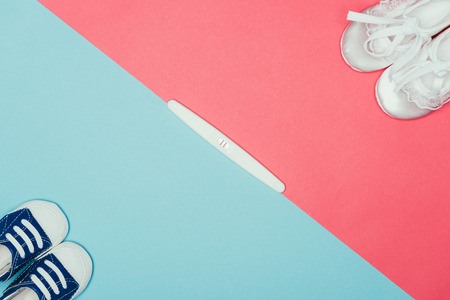 arrangement of childish shoes and pregnancy testの写真素材