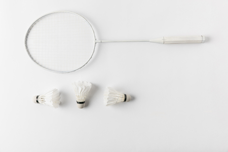 badminton racket with suttercocks in row on white surfaceの写真素材