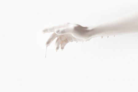 female arm in white paint isolated on whiteの写真素材