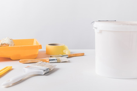 bucket with paint and tools for repairs