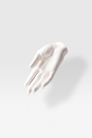abstract sculpture in shape of human palm in white paintの写真素材