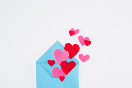 blue envelope with paper hearts isolated on white, valentines day conceptの写真素材