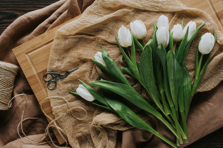 top view of white spring tulips on wooden board for international womens dayの写真素材