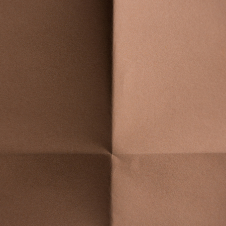 close-up shot of brown colored folded paper for backgroundの写真素材