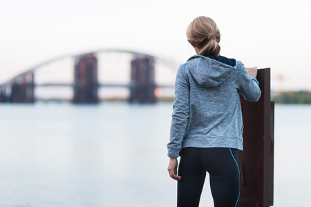 sportswoman standing on quay