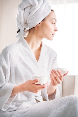 woman holding jar of creamの写真素材