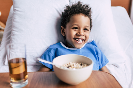 african american boy with breakfast in clinicの写真素材