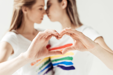 Female couple showing heart with handsの写真素材