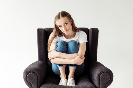 Girl sitting on armchairの写真素材