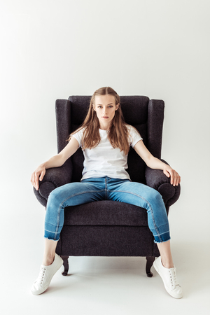 Girl sitting on armchairの写真素材
