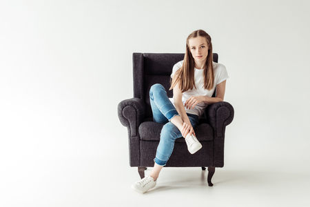 Girl sitting on armchairの写真素材