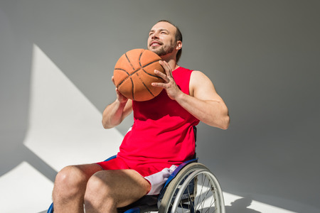 Disabled sportsman throwing basketballの写真素材