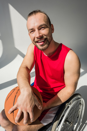 Disabled sportsman holding basketballの写真素材