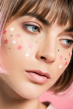 woman with pink stars on faceの写真素材