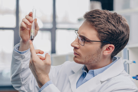 biologist with plant in flaskの写真素材